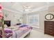Bright bedroom featuring a ceiling fan, and a window seat for relaxation and natural light at 3887 Hickory Manor Dr, Suwanee, GA 30024