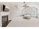 Spacious primary bedroom with a vaulted ceiling, fireplace, and ample natural light from large windows at 3887 Hickory Manor Dr, Suwanee, GA 30024