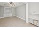 Bonus room features neutral paint, ceiling fan, and built-in shelves and cabinets at 3887 Hickory Manor Dr, Suwanee, GA 30024
