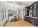 Bright dining area featuring hardwood floors, custom built-in cabinets, and open access to the living room and stairway at 3887 Hickory Manor Dr, Suwanee, GA 30024