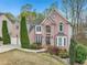 Brick two-story home with well-manicured landscaping, mature trees, and a two-car garage at 3887 Hickory Manor Dr, Suwanee, GA 30024