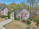 Charming two-story brick home with a well-manicured lawn and mature landscaping at 3887 Hickory Manor Dr, Suwanee, GA 30024
