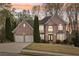 Charming two-story brick home with a two-car garage and well-manicured lawn in a lovely residential neighborhood at 3887 Hickory Manor Dr, Suwanee, GA 30024