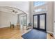 Bright foyer featuring hardwood floors, a soaring ceiling, and elegant double front doors at 3887 Hickory Manor Dr, Suwanee, GA 30024