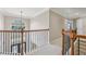 Hallway view features wood handrails, iron balusters, and neutral paint and carpet at 3887 Hickory Manor Dr, Suwanee, GA 30024