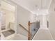 Hallway featuring a wooden railing and carpeted floors, leading to various rooms in the home at 3887 Hickory Manor Dr, Suwanee, GA 30024
