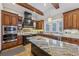 Beautiful kitchen features wooden cabinets, granite countertops, and stainless steel appliances at 3887 Hickory Manor Dr, Suwanee, GA 30024