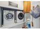 Laundry room with a washer and dryer, overhead cabinets, and storage solutions for laundry essentials at 3887 Hickory Manor Dr, Suwanee, GA 30024