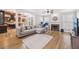 Spacious living room with hardwood floors, a fireplace, and an open layout connecting to the kitchen at 3887 Hickory Manor Dr, Suwanee, GA 30024