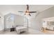 Bright primary bedroom with arched windows and a ceiling fan, with an en-suite bathroom at 3887 Hickory Manor Dr, Suwanee, GA 30024