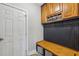 Mudroom with bench seating, coat hooks, overhead cabinets, and storage baskets for organizing your everyday essentials at 3887 Hickory Manor Dr, Suwanee, GA 30024