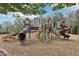 A colorful, mulch-covered community playground features multiple slides, climbing structures, and shaded areas for outdoor fun at 3887 Hickory Manor Dr, Suwanee, GA 30024