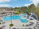 Community pool including lap lanes, a waterslide, splash pad, tables with chairs, and plenty of lounge seating at 3887 Hickory Manor Dr, Suwanee, GA 30024