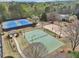 Aerial view of community tennis and volleyball courts surrounded by lush greenery and mature trees at 3887 Hickory Manor Dr, Suwanee, GA 30024
