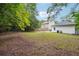 Large backyard with green grass with new construction in the background at 1382 Elizabeth Ln, Atlanta, GA 30344