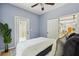 Light blue bedroom with stylish decor, ceiling fan, and a door to the outside at 1382 Elizabeth Ln, Atlanta, GA 30344
