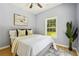 Comfortable bedroom with a large window providing natural light, neutral decor, and a peaceful atmosphere at 1382 Elizabeth Ln, Atlanta, GA 30344