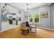 Bright dining area featuring hardwood floors, modern lighting, and windows allowing for an abundance of natural light at 1382 Elizabeth Ln, Atlanta, GA 30344