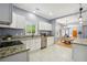 Open kitchen featuring stainless steel appliances, granite countertops, white cabinetry, and tile flooring at 1382 Elizabeth Ln, Atlanta, GA 30344