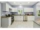 Modern kitchen with stainless steel appliances, granite countertops, white cabinetry, and tiled flooring offering style at 1382 Elizabeth Ln, Atlanta, GA 30344