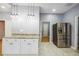 Kitchen area features stainless steel appliances, a breakfast bar, and modern pendant lighting, creating an inviting space at 1382 Elizabeth Ln, Atlanta, GA 30344