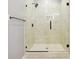 Modern tiled shower featuring a glass door and black matte hardware at 1382 Elizabeth Ln, Atlanta, GA 30344