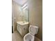 Well-lit bathroom with a modern mirror and a toilet at 1535 Wilkes Crest Dr, Dacula, GA 30019