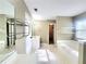 Large bathroom with tub, vanity, shower, and mirrored accent wall at 1535 Wilkes Crest Dr, Dacula, GA 30019