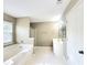 Bright bathroom with tub, shower, vanity, and plenty of natural light at 1535 Wilkes Crest Dr, Dacula, GA 30019