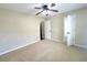 Large bedroom featuring two entry doors and ceiling fan at 1535 Wilkes Crest Dr, Dacula, GA 30019