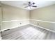 Bright bedroom featuring gray floors, neutral paint, ceiling fan and white trim at 1535 Wilkes Crest Dr, Dacula, GA 30019