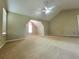 Carpeted bedroom with vaulted ceiling, fan, and natural light from the windows at 1535 Wilkes Crest Dr, Dacula, GA 30019