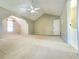 Bright carpeted bedroom with vaulted ceiling, fan, and bathroom access at 1535 Wilkes Crest Dr, Dacula, GA 30019