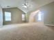 Spacious bedroom with vaulted ceiling, ceiling fan, neutral carpet, and natural light at 1535 Wilkes Crest Dr, Dacula, GA 30019