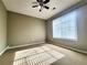 Bright bedroom featuring a ceiling fan and window with natural light at 1535 Wilkes Crest Dr, Dacula, GA 30019