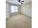 Bedroom with carpet and fan featuring a window at 1535 Wilkes Crest Dr, Dacula, GA 30019