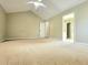 Large carpeted bedroom with vaulted ceiling and adjoining bathroom for convenience at 1535 Wilkes Crest Dr, Dacula, GA 30019