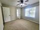 Bright, open bedroom featuring a ceiling fan and exterior views at 1535 Wilkes Crest Dr, Dacula, GA 30019