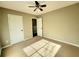 Standard bedroom featuring a ceiling fan, closet and neutral carpeting at 1535 Wilkes Crest Dr, Dacula, GA 30019