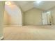 Well-lit bedroom with neutral carpet, ceiling fan, and adjacent bathroom at 1535 Wilkes Crest Dr, Dacula, GA 30019
