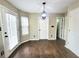 Bright dining area with hardwood floors, modern light fixture, and access to the backyard at 1535 Wilkes Crest Dr, Dacula, GA 30019