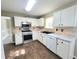Well-lit kitchen with white cabinets, stainless steel appliances, and tile backsplash at 1535 Wilkes Crest Dr, Dacula, GA 30019