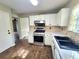 Well-lit kitchen with white cabinets, stainless steel appliances, and tile backsplash at 1535 Wilkes Crest Dr, Dacula, GA 30019
