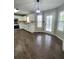 Open kitchen featuring stainless steel appliances, hardwood floors, and outdoor access at 1535 Wilkes Crest Dr, Dacula, GA 30019