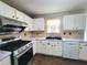 Charming kitchen with white cabinets, stainless steel appliances, and modern countertops at 1535 Wilkes Crest Dr, Dacula, GA 30019