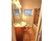 Bathroom with a stand alone vanity, tiled floor, and a tub with a glass shower door at 2089 Lenox Rd, Atlanta, GA 30324