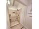 Updated shower features neutral tiling, built-in shelves, and modern shower head at 2089 Lenox Rd, Atlanta, GA 30324