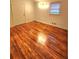 Bedroom with gleaming hardwood floors, bright window, and neutral walls at 2089 Lenox Rd, Atlanta, GA 30324