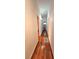 Hallway featuring hardwood floors and access to a bathroom, creating a seamless transition between spaces at 2089 Lenox Rd, Atlanta, GA 30324