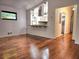 Open-concept living room with hardwood floors and pass-through view of the modernized kitchen, creating a seamless flow at 2089 Lenox Rd, Atlanta, GA 30324